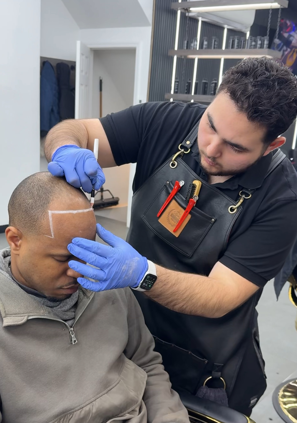 SMP artist drawing a custom hairline on a client